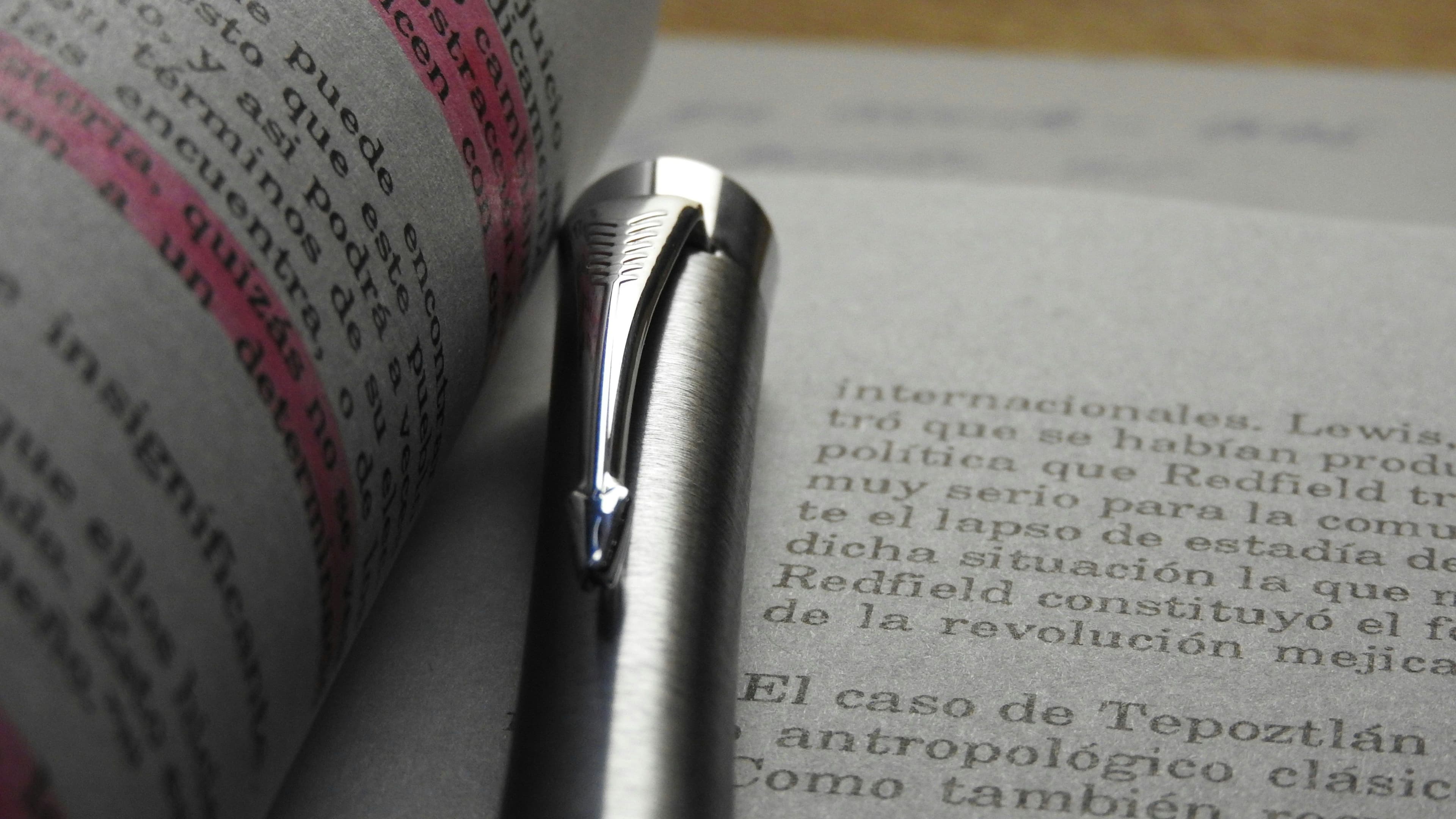 a pen laying on top of an open book